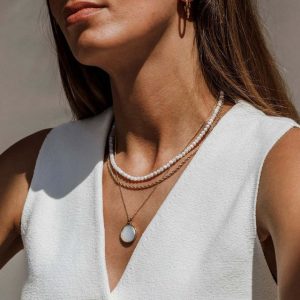 Woman wearing a Crystal Brown pendant necklace