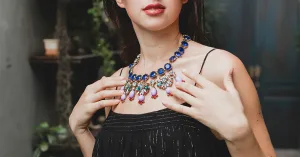 Woman wearing a layered crystal necklace with a casual outfit
