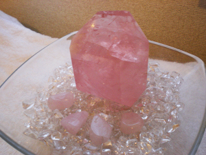 Person meditating with Pink Quartz Crystal