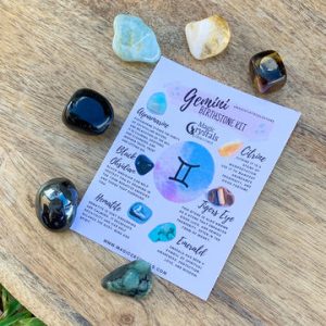 A collection of crystals with a Gemini zodiac sign in the background