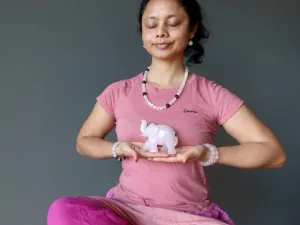 A person meditating with Pink Quartz Crystal