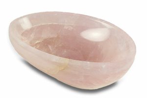 Polished rose quartz stones in a bowl